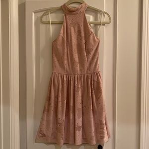 Nude high-neck, open-back dress